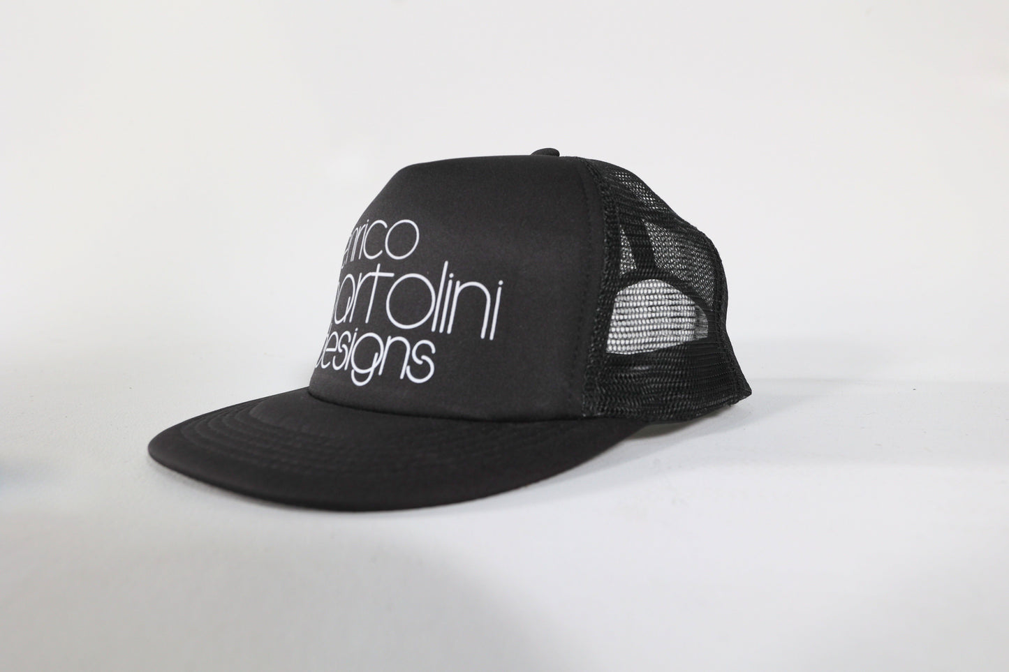 Black trucker cap with white text on a white background
