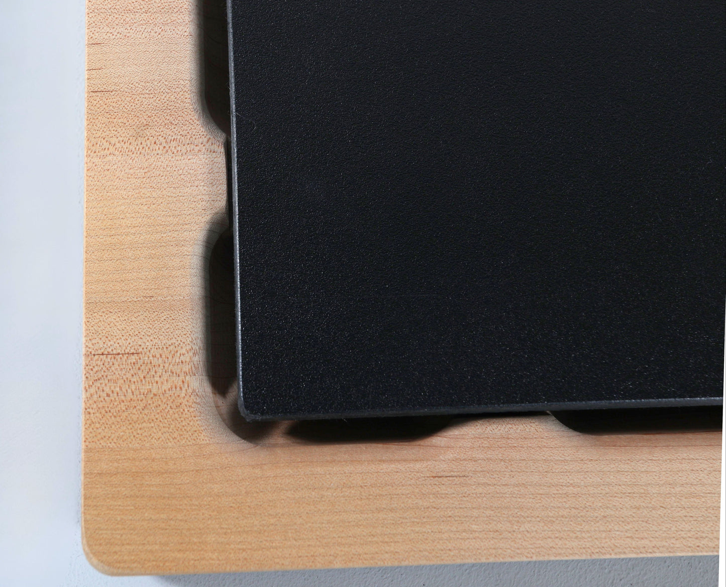 Up close shot of a Wooden Cutting butcher block with a food grade plastic cutting board insert on a white background