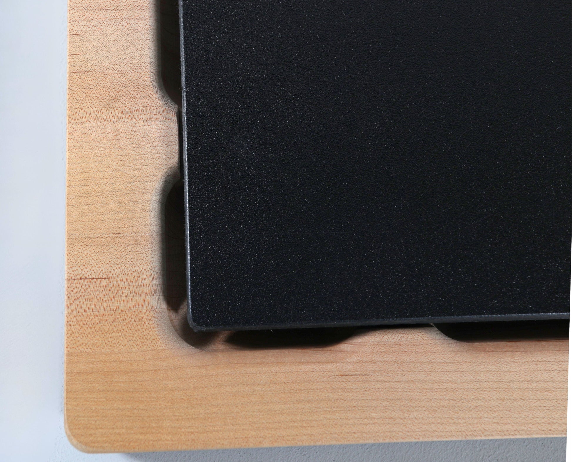 Up close shot of a Wooden Cutting butcher block with a food grade plastic cutting board insert on a white background