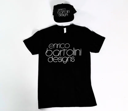 Black t-shirt and cap with 'enrico bartolini designs' text on a white background